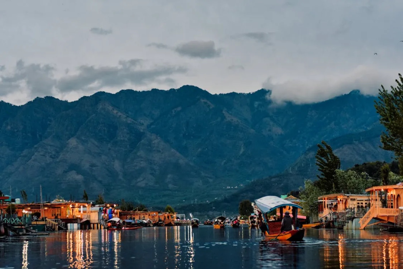 Houseboats and a shikara at dusk on Dal Lake, Srinagar